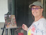 Sarah Baptist at easel plein air painting in Baltimore, MD. Sarah is working on painting called CVS.